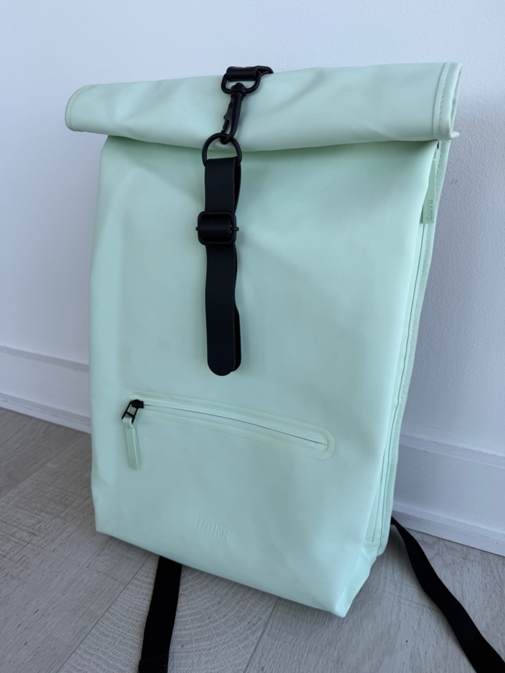 Rains Mint Green Rolltop Backpack.